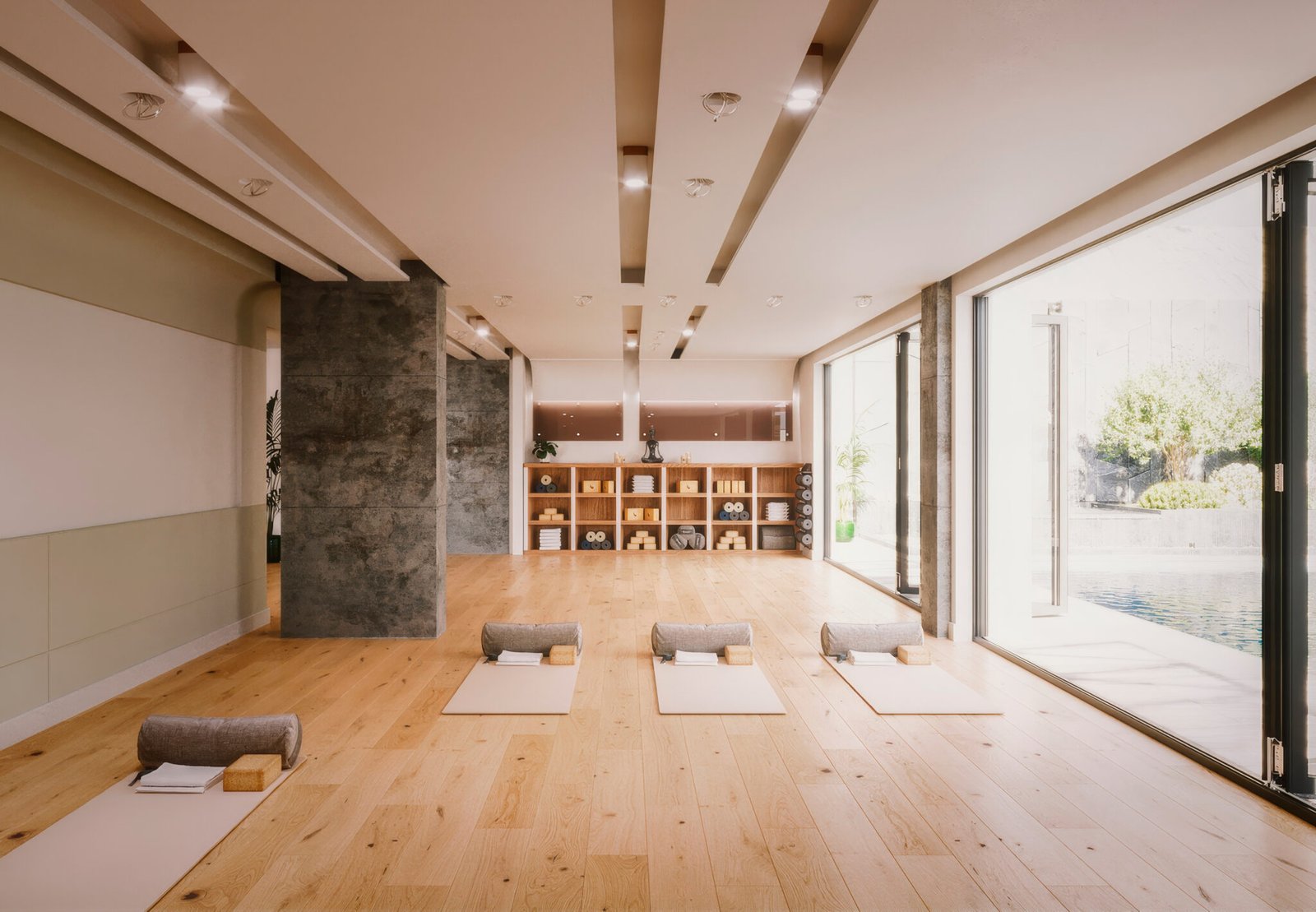 Serene yoga studio with wooden flooring, natural lighting, meditation cushions, and a peaceful view of nature through glass doors.